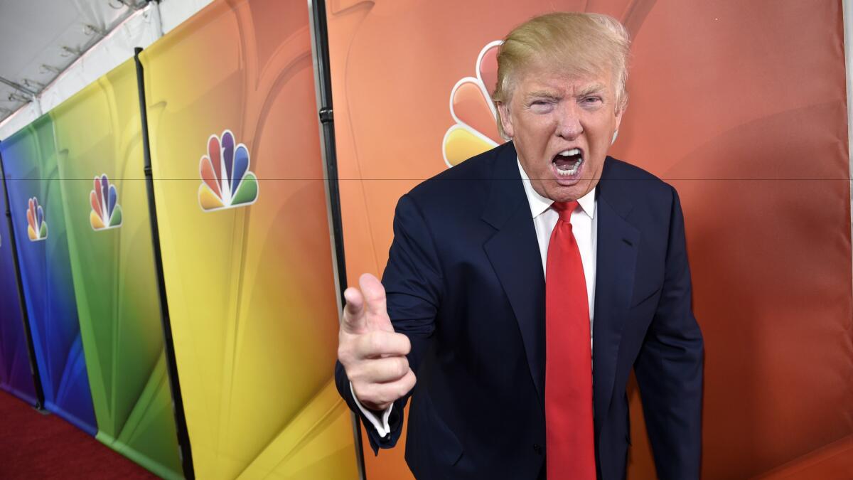 Donald Trump hams it up for photographers during a 2015 promotional appearance for "The Celebrity Apprentice" in Pasadena.