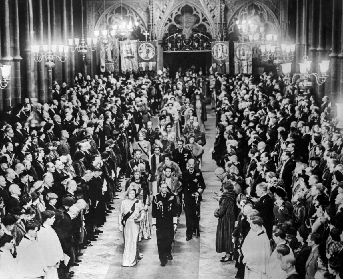 King George VI and Queen Elizabeth lead the procession of royal guests down the aisle of Westminster Abbey after the wedding of Princess Elizabeth and Prince Phillip.