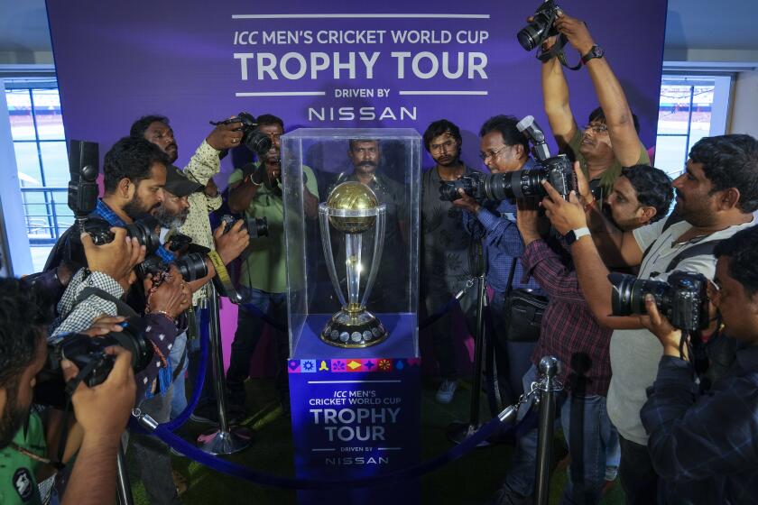 Photographers take pictures during a trophy tour of the upcoming ICC Men's Cricket World Cup at the Rajiv Gandhi International Cricket Stadium in Hyderabad, India, Thursday, Sept. 21, 2023. (AP Photo/Mahesh Kumar A.)