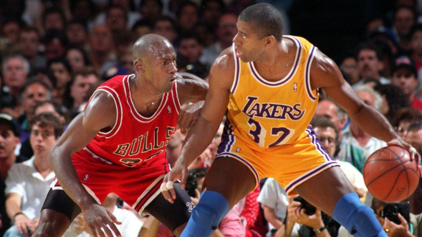 Lakers star Magic Johnson tries to drive past Chicago Bulls great Michael Jordan during the 1991 NBA Finals.