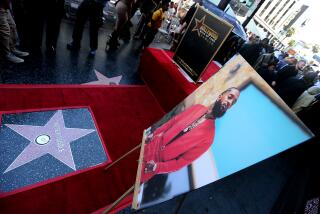 HOLLYWOOD, CALIF. - AUG. 15, 2022. A Hollywood Walk of Fame star for slain rapper Nipsey Hussle was unveiled during a sidewalk ceremony along Hollywood Boulevard in Hollywood on Monday, Aug. 15, 2022. Hussle was shot multiple times outside his South Los Angeles clothing store in 2019 by an associate over a personal matter. He was known and beloved for his community activism and local philanthropy. (Luis Sinc0 / Los Angeles Times)