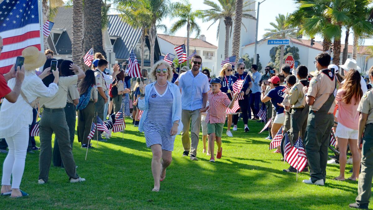 Bystanders shot photos as O.C. Supervisor Katrina Foley led 10 Olympians to the reception area after the parade.