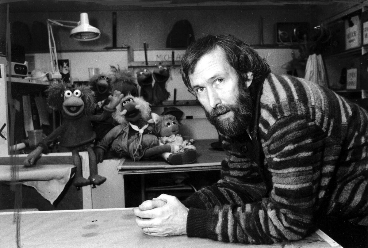 Jim Henson with his "Muppets" pose for a photo at Henson's 69th Street office in New York.