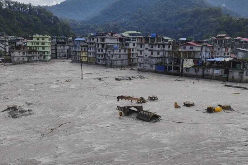 Buildings are inundated after flash floods triggered by sudden heavy rainfall swamped Rangpo town in Sikkim, India, Friday, Oct. 6. 2023. A flood that burst through a major hydroelectric dam in India's Himalayan northeast killed at least 31 people, officials said Friday, as ice-cold water swept through mountain towns, washing away houses and bridges and forcing thousands of people to leave their homes. The flood began shortly after midnight Wednesday, when a glacial lake high in the mountains overflowed after a heavy rainfall. (AP Photo/Prakash Adhikari)