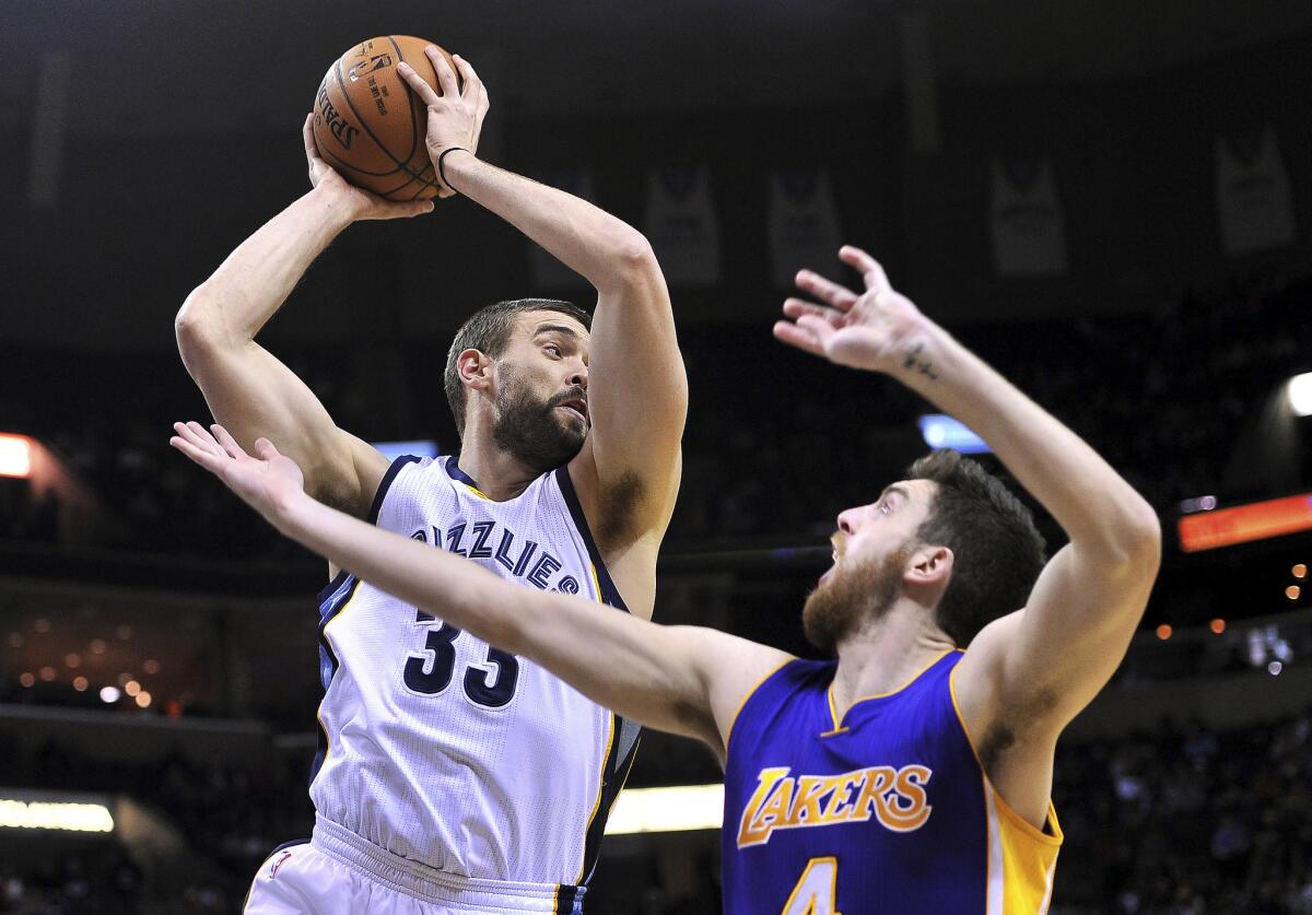 Grizzlies center Marc Gasol grabs a rebound over Lakers forward Ryan Kelly in the first half Friday in Memphis.