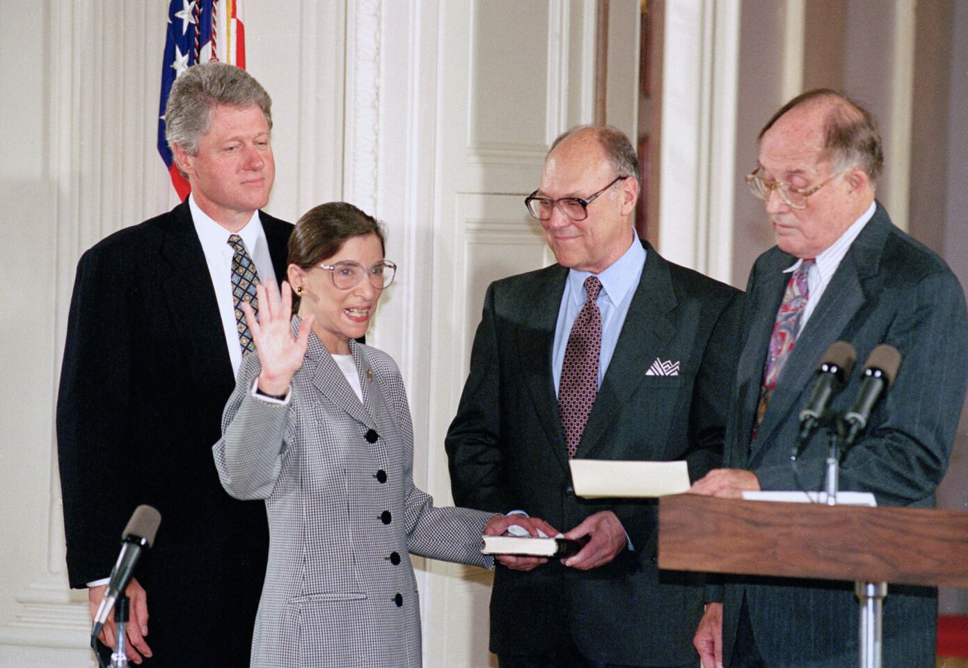 Justice Ruth Bader Ginsburg raises her right hand, with her left hand on a Bible, while taking her oath in 1993