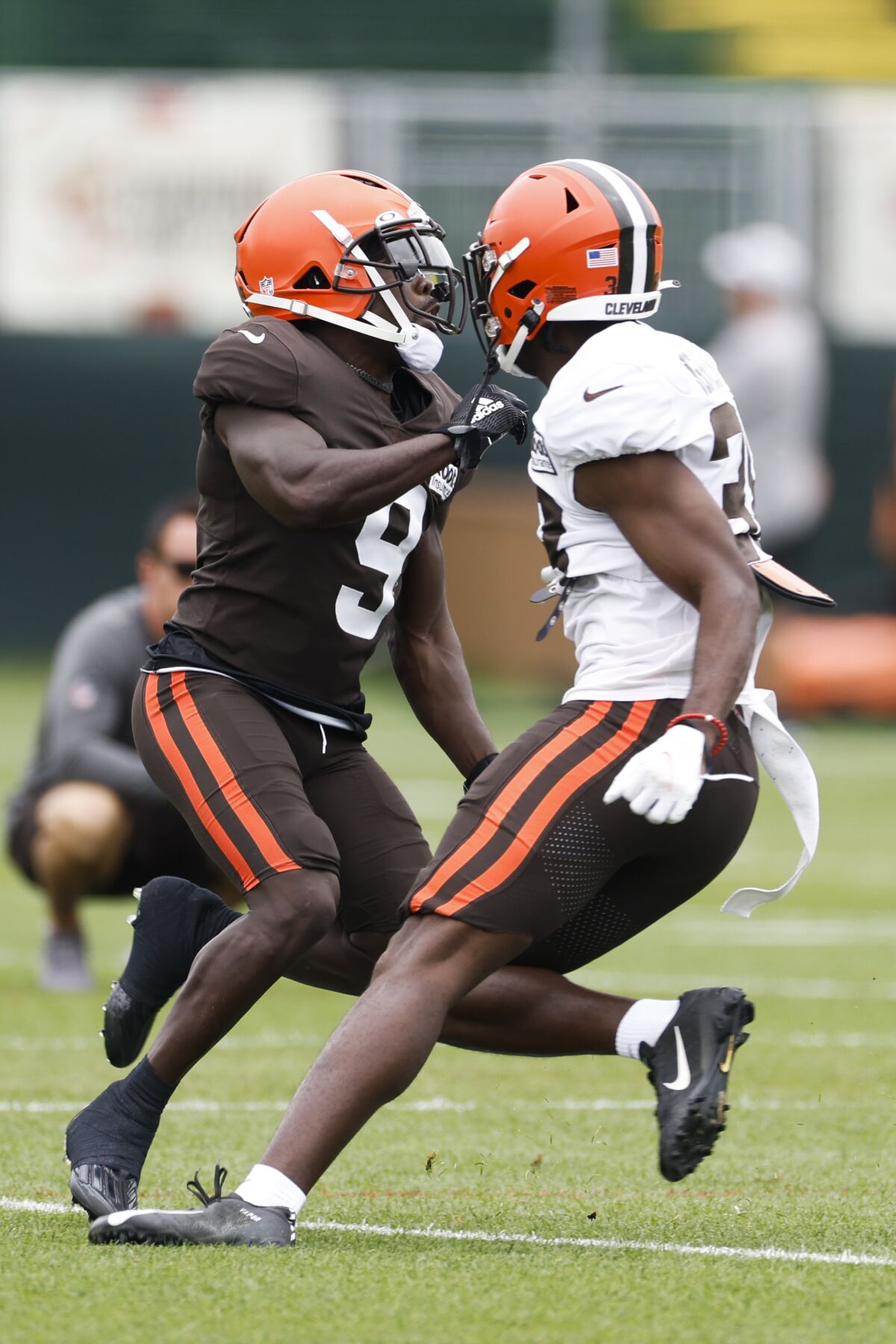 Cleveland Browns wide receiver Jakeem Grant Sr. (9) goes up for a pass against cornerback A.J. Green and is injured on the play during the NFL football team's training camp, Tuesday, Aug. 9, 2022, in Berea, Ohio. (AP Photo/Ron Schwane)
