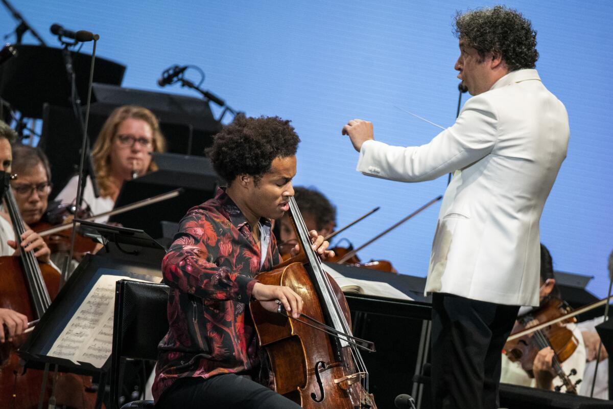 Cellist Sheku Kanneh-Mason performs at the Hollywood Bowl with Gustavo Dudamel and the L.A. Phil behind him. 