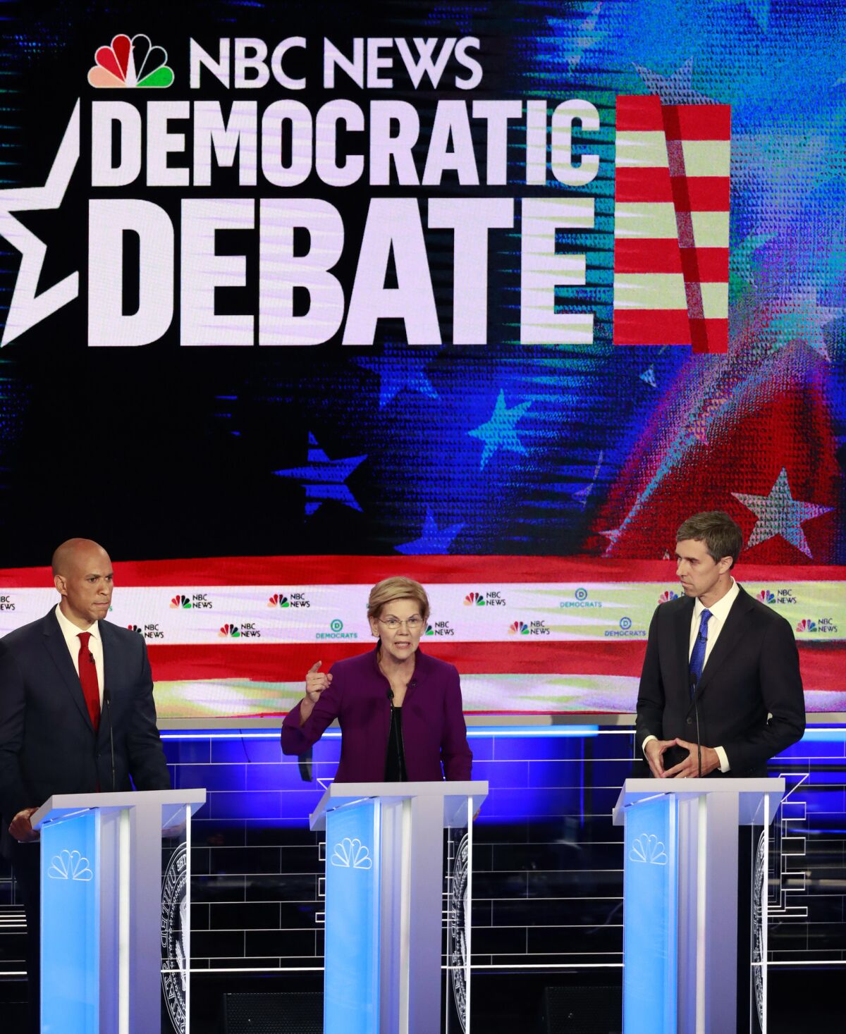 Democratic presidential candidate Sen. Elizabeth Warren, center, speaks during the debate flanked by Sen. Cory Booker, left, and former Rep. Beto O'Rourke.