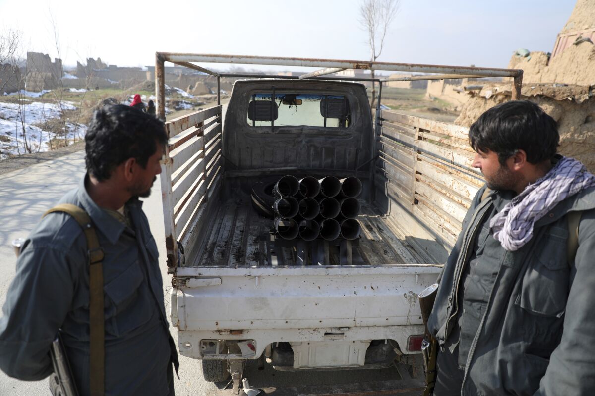 Afghan security personnel observe a vehicle that was used to fire rockets at Bagram Airfield on Saturday.