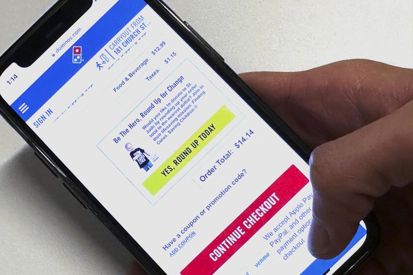 An option to donate to St. Jude Children's Research Hospital appears on the Domino's app in a photo taken in New York on Wednesday, May 15, 2024. Domino's is the latest and largest example of philanthropic allies new and old finding success through "checkout charity." (AP Photo/Peter Morgan)