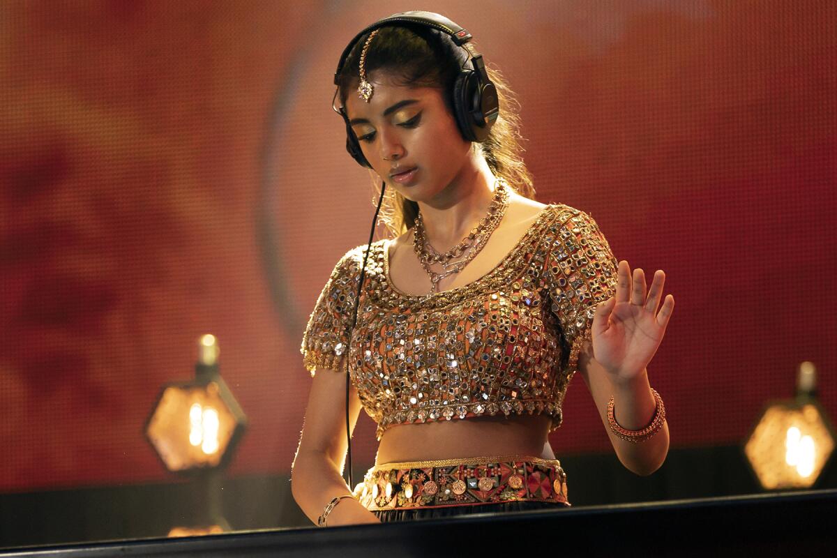 Avantika Vandanapu wears headphones as she DJs in "Spin" on Disney.