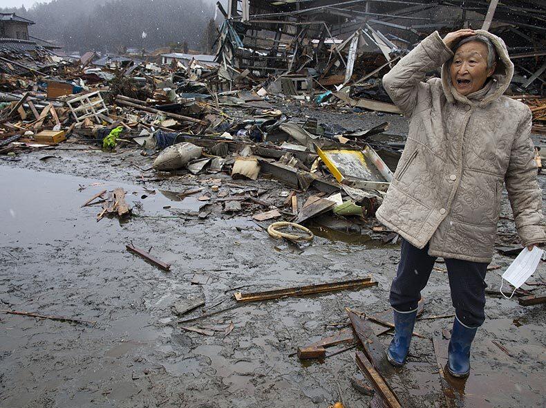 A woman in Kesennuma, Japan, visits the rubble of the village where she had her home. The area was destroyed in the tsunami that followed the massive earthquake that struck March 11 off Japan. As the death toll continues to rise, the country is struggling to contain a potential nuclear meltdown after the Fukushima Daiichi plant was seriously damaged in the disaster.