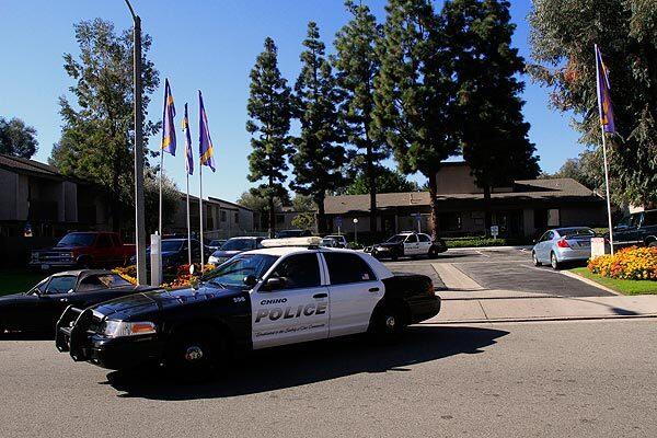Chino police squad cars leave an apartment complex in the 12300 block of Marshall Avenue.
