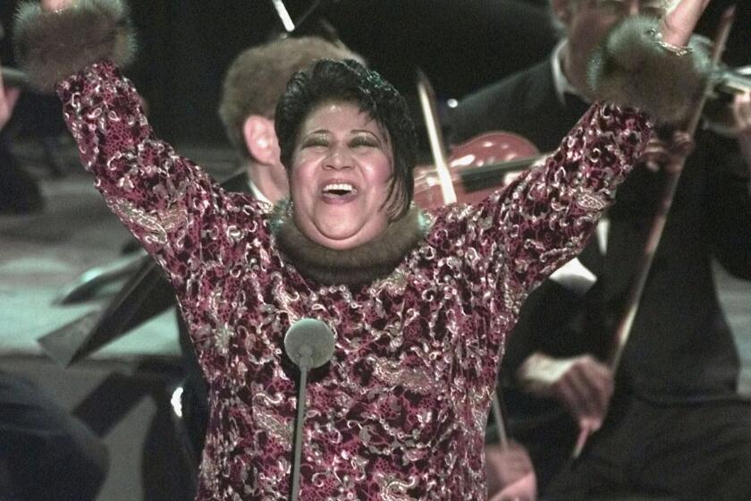 Aretha Franklin raises her arms in jubilation after standing in for Luciano Pavarotti at the last minute at the 40th Annual Grammy Awards Wednesday, Feb. 25, 1998, at Radio City Music Hall in New York. Franklin sang "Nessun Dorma" from Puccini's "Turandot" when Pavarotti called in sick. (AP Photo/Mark Lennihan)