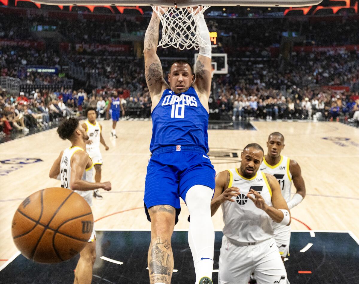 Clippers center Daniel Theis hangs from the rim after dunking over Utah's Talen-Horton Tucker.