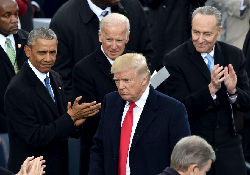 US President Donald Trump is applauded by former President Barack Obama, former Vice President Joe Biden and Sen. Chuck Schumer, D-New York, during Trump's inauguration ceremonies at the US Capitol in Washington, DC, on January 20, 2017.