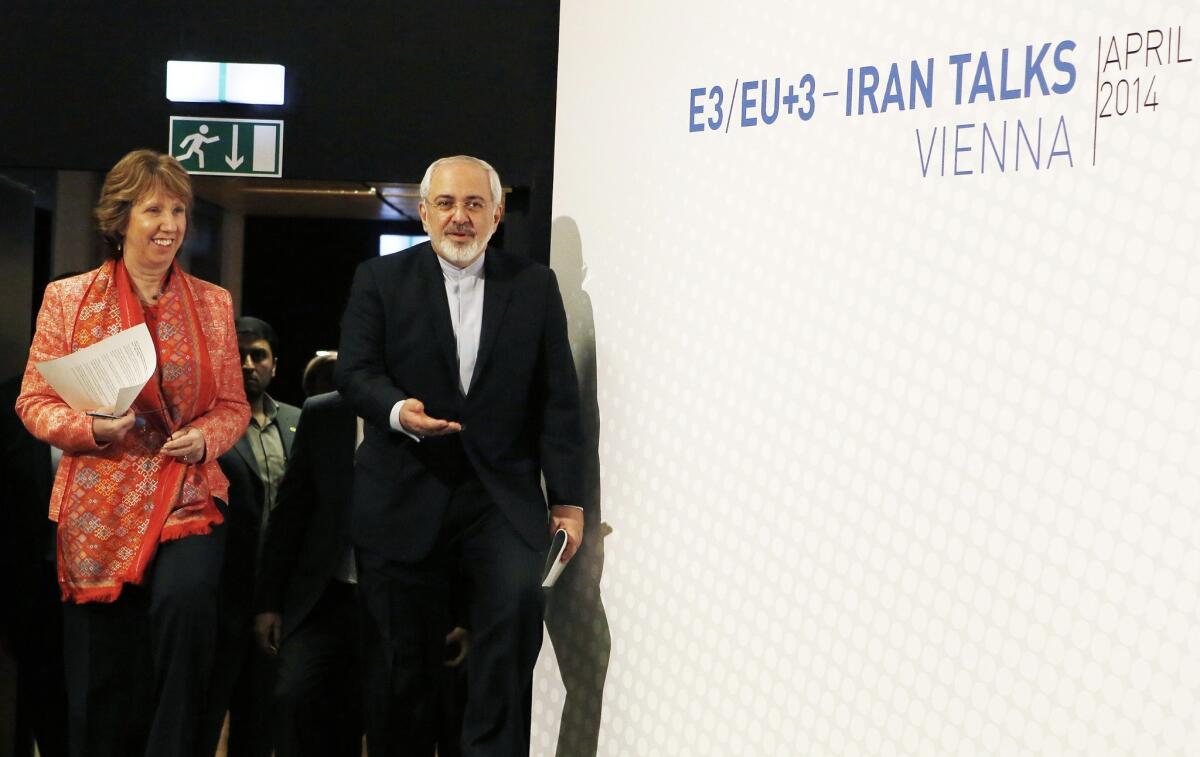 Iran is complying with the terms of an interim nuclear deal with six foreign powers by diluting or converting its stockpile of enriched uranium, IAEA officials confirmed Wednesday. Above, Iranian Foreign Minister Mohammad Javad Zarif and European Union foreign affairs chief Catherine Ashton attend talks in Vienna last week aimed at a permanent nuclear accord.