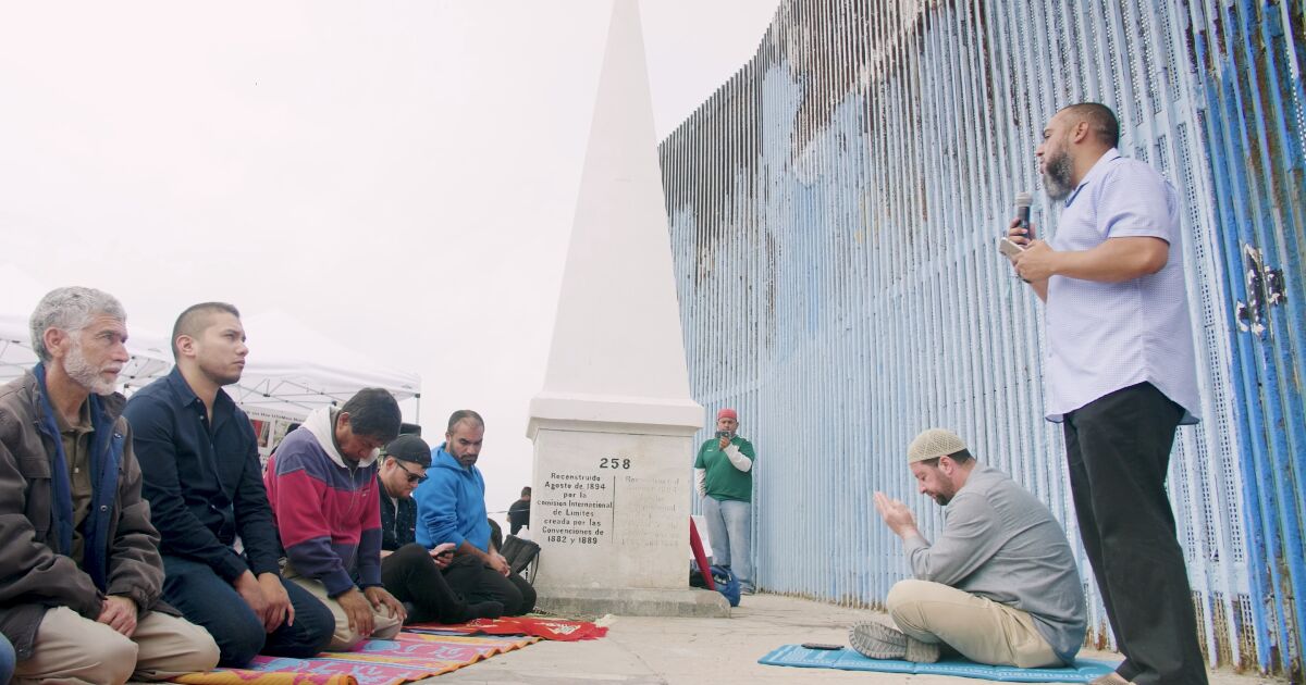 Imam Wesley Lebron leading the supplication at the US/ Mexico border at Friendship Park in Tijuana. From the film “A Prayer Beyond Borders” Directed by Ala’Khan & Reynaldo Escoto