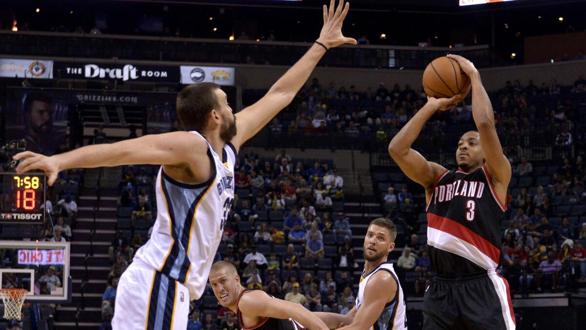 Trail Blazers guard C.J. McCollum pulls up for a jump shot over Grizzlies center Marc Gasol during the first half Sunday.