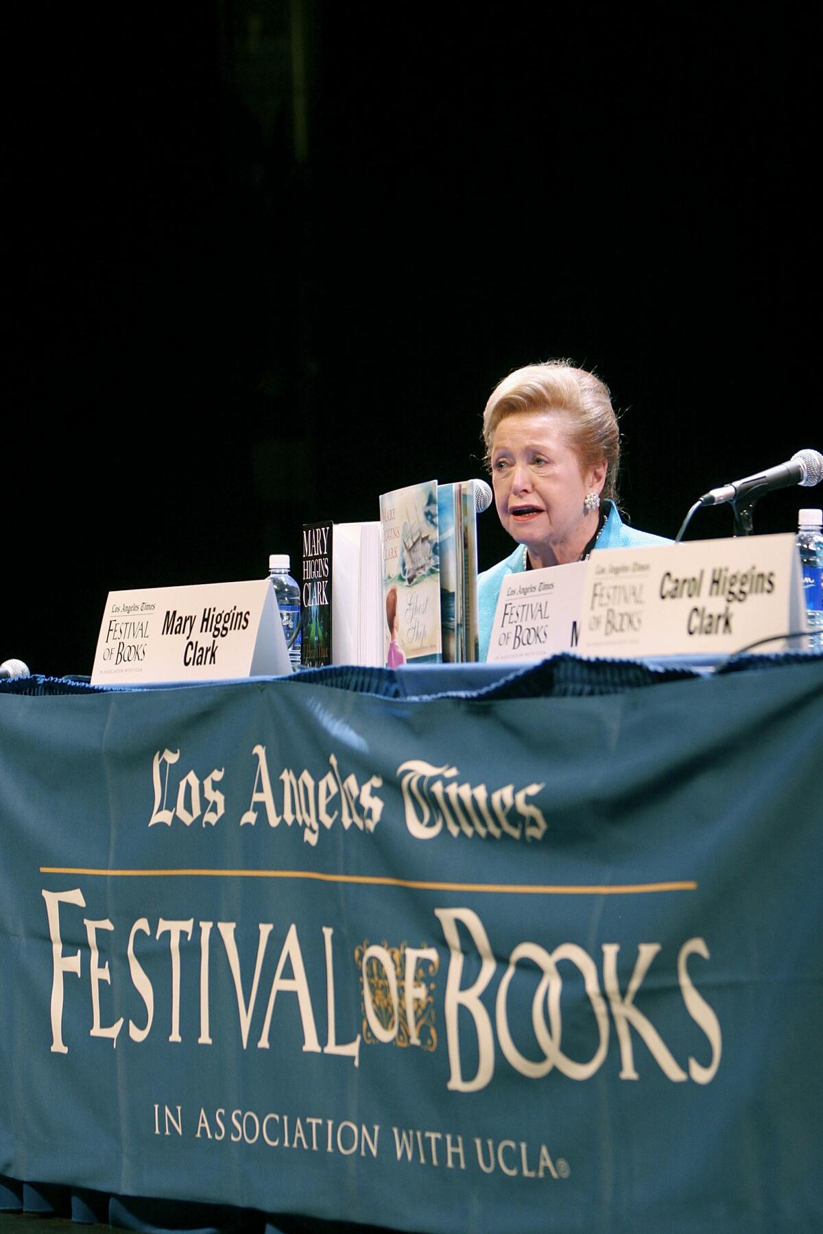 Mary Higgins Clark at a table draped with a "Los Angeles Times Festival of Books" banner.