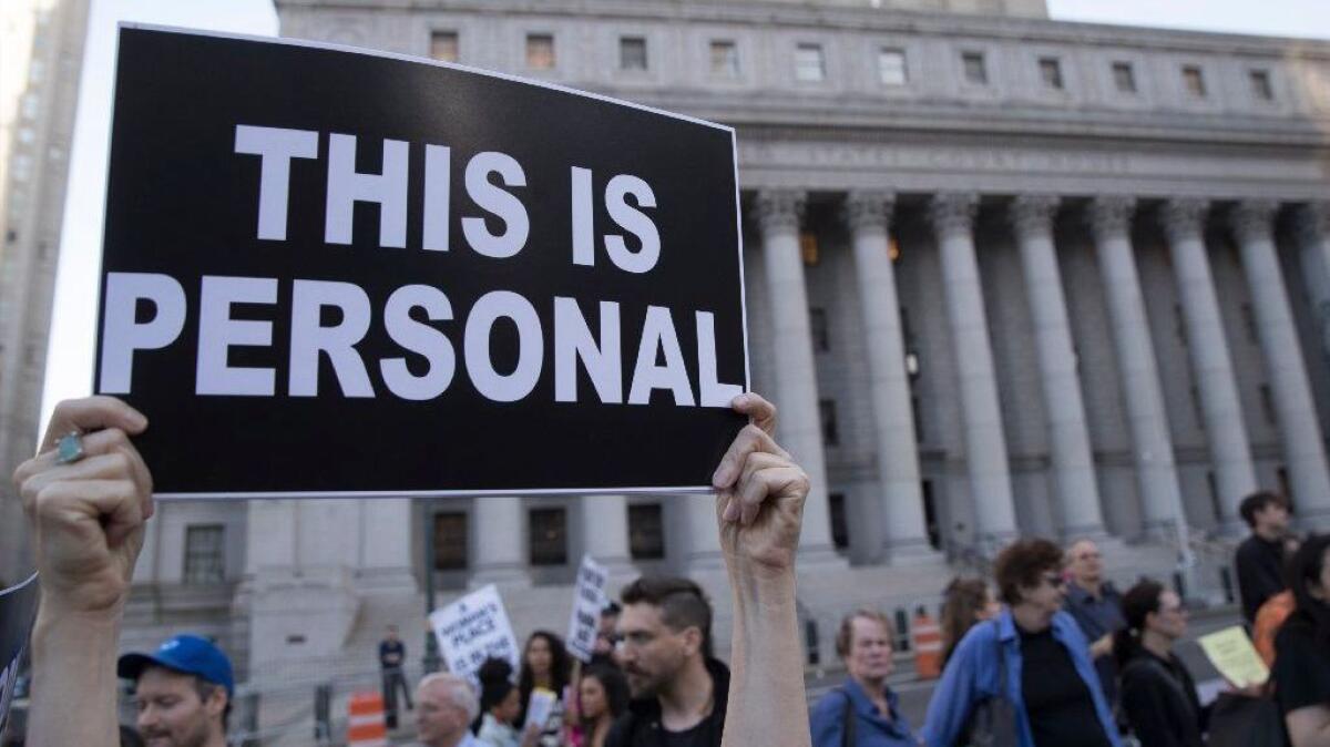 A demonstrator holds up a sign during a protest against abortion bans on May 21 in New York.