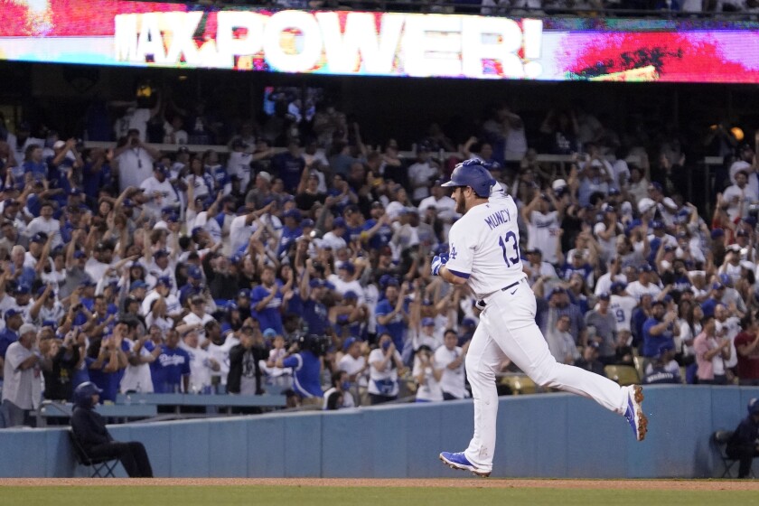 Max Muncy gestures as he rounds third after hitting a solo home run during the third inning of the Dodgers' 3-1 win.