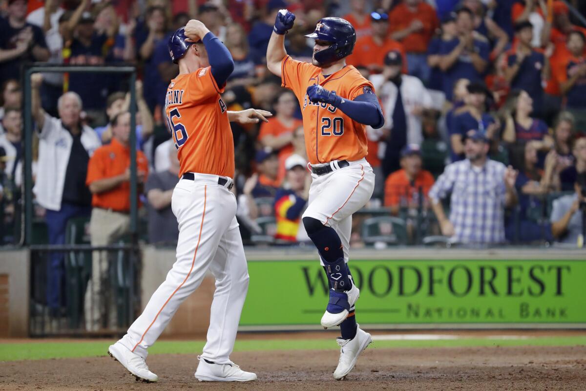 The Astros' Chas McCormick, right, and Trey Mancini celebrate after they scored on McCormick's two-run homer Sept. 9, 2022.
