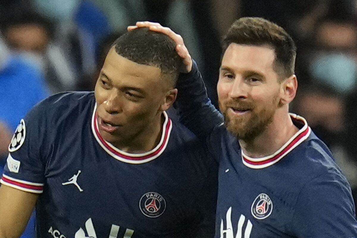PSG's Lionel Messi, right, congratulates PSG's Kylian Mbappe after he scored his side's first goal during the Champions League, round of 16, second leg soccer match between Real Madrid and Paris Saint-Germain at the Santiago Bernabeu stadium in Madrid, Spain, Wednesday, March 9, 2022. (AP Photo/Manu Fernandez)
