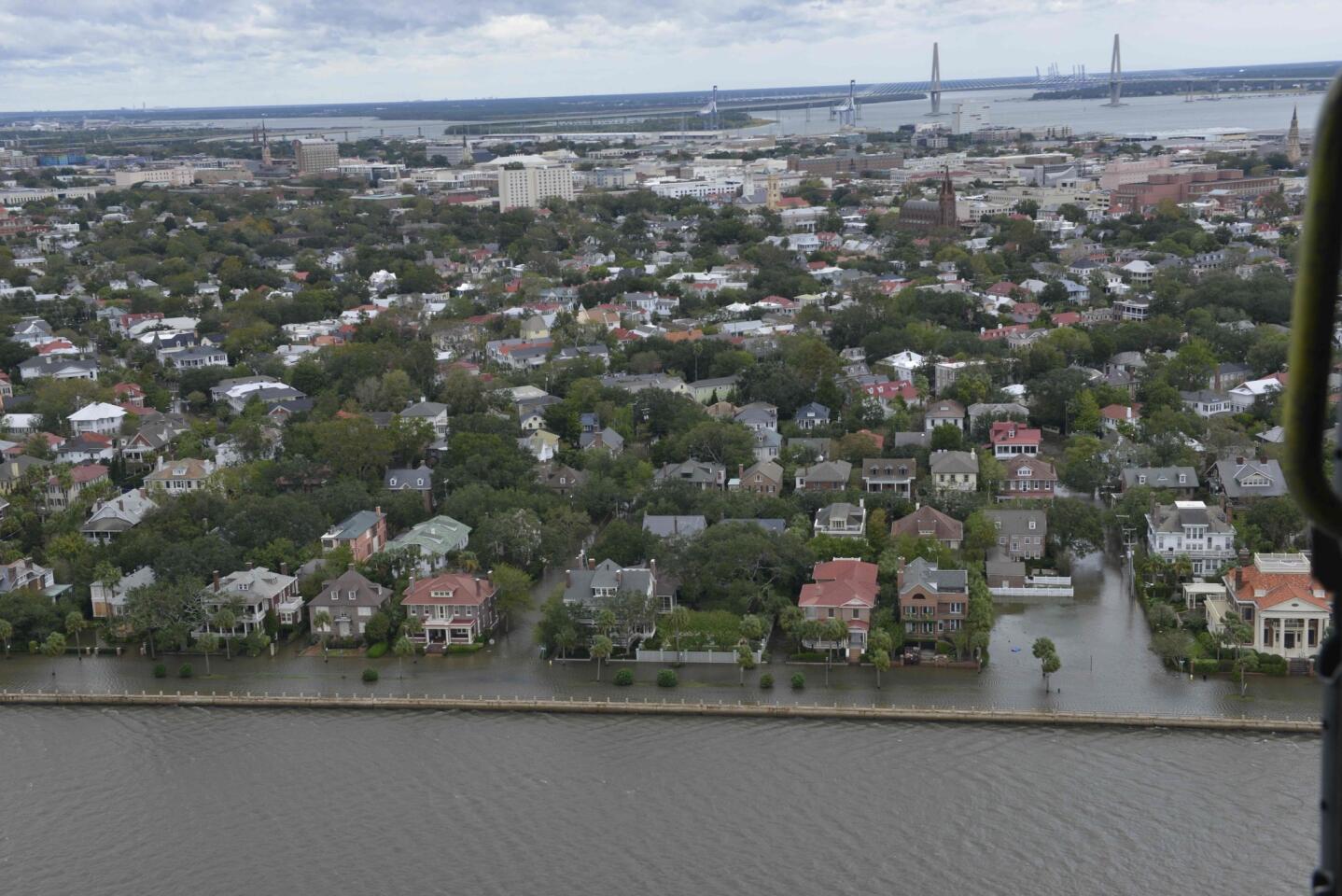 An MH-60 helicopter flies over flooded areas of Charleston, South Carolina, after Hurricane Matthe passed through on Oct. 8, 2016.