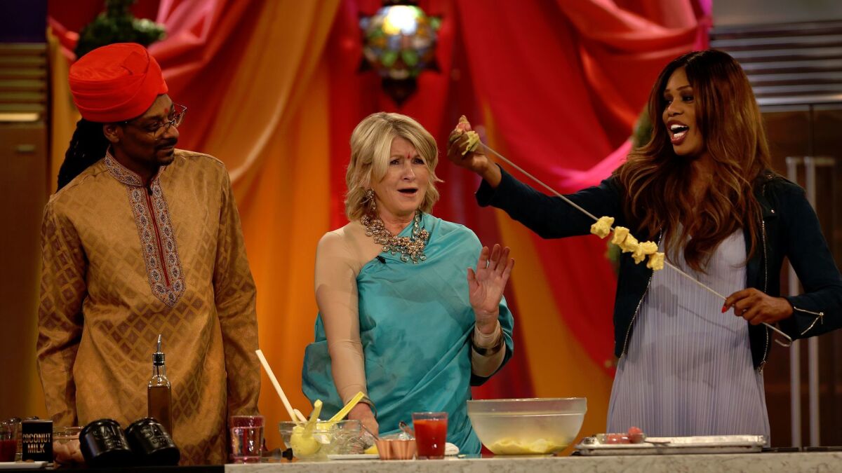 Snoop Dogg and Martha Stewart watch as special guest Laverne Cox puts chicken onto a skewer on VH1's "Martha & Snoop's Potluck Dinner Party."