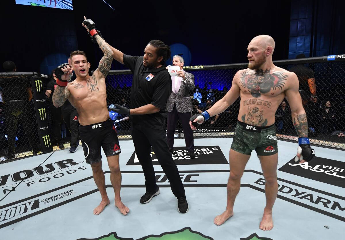 Dustin Poirier celebrates after being declared the winner by referee Herb Dean following his TKO win over Conor McGregor.