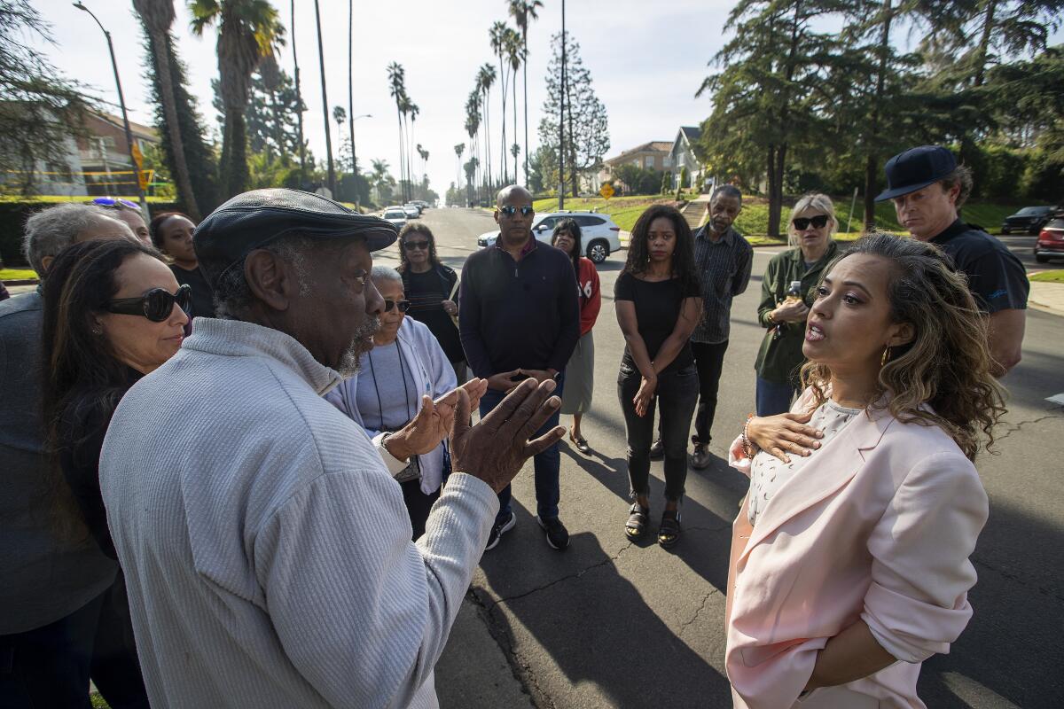 Resident Douglas Alston, left, voices his concerns to Aura Vasquez, a candidate for Los Angeles City Council District 10.