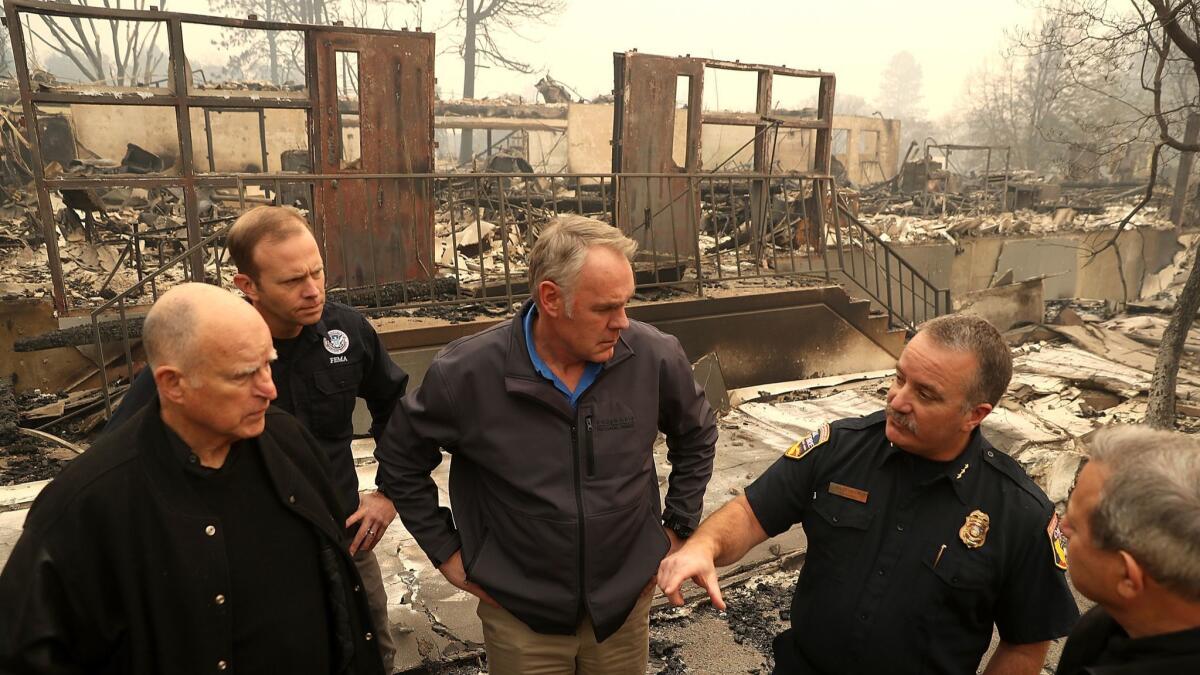 FEMA Administrator Brock Long, second from left, joins Gov. Jerry Brown and others in November to tour a school burned by the Camp Fire in Paradise.