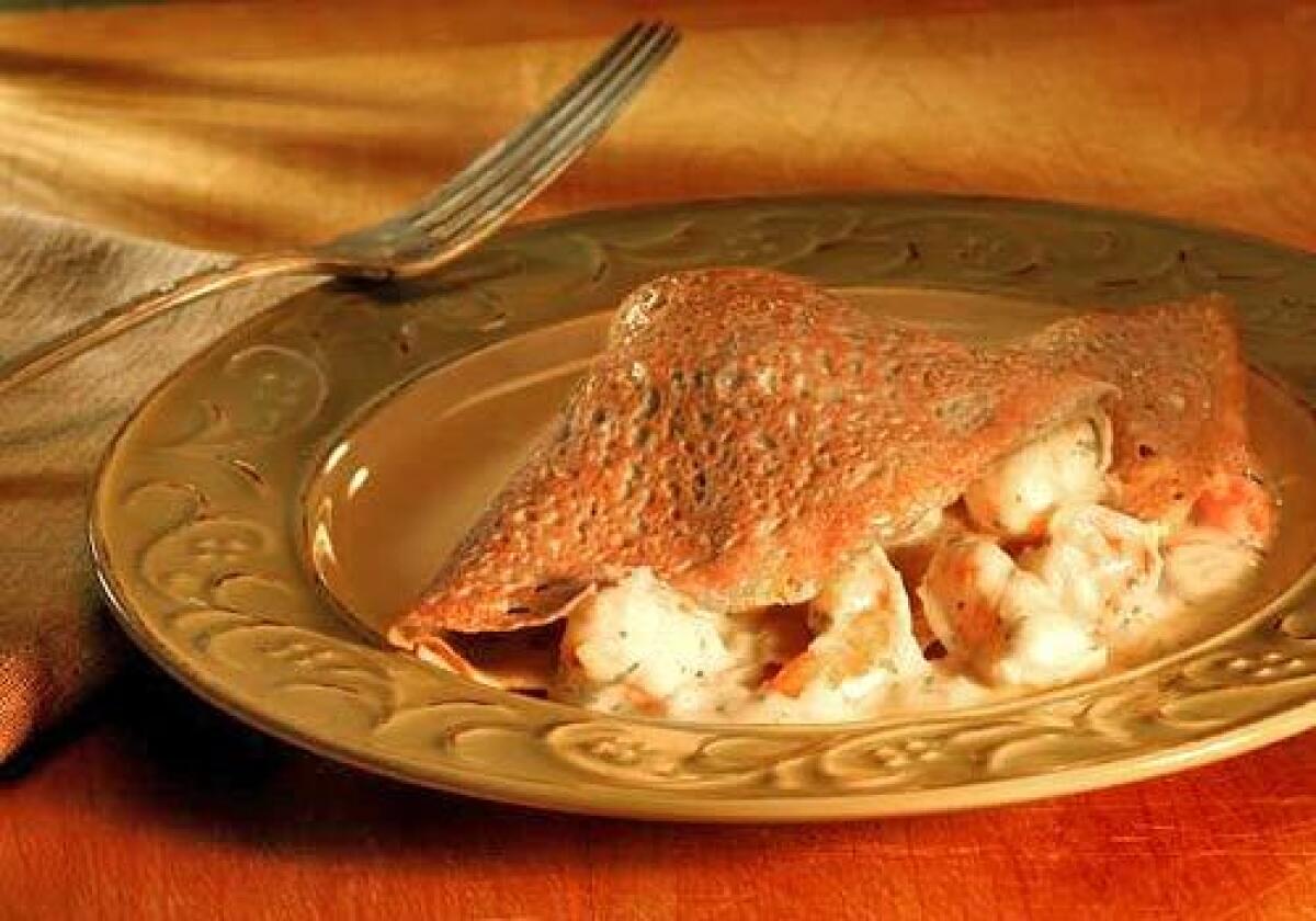 A buckwheat crepe, or galette, is filled with seafood in a light cream sauce made with crème fraîche instead of the usual, heavier roux. Make sure to have the filling ready before making the crepes  theyre best right out of the pan.