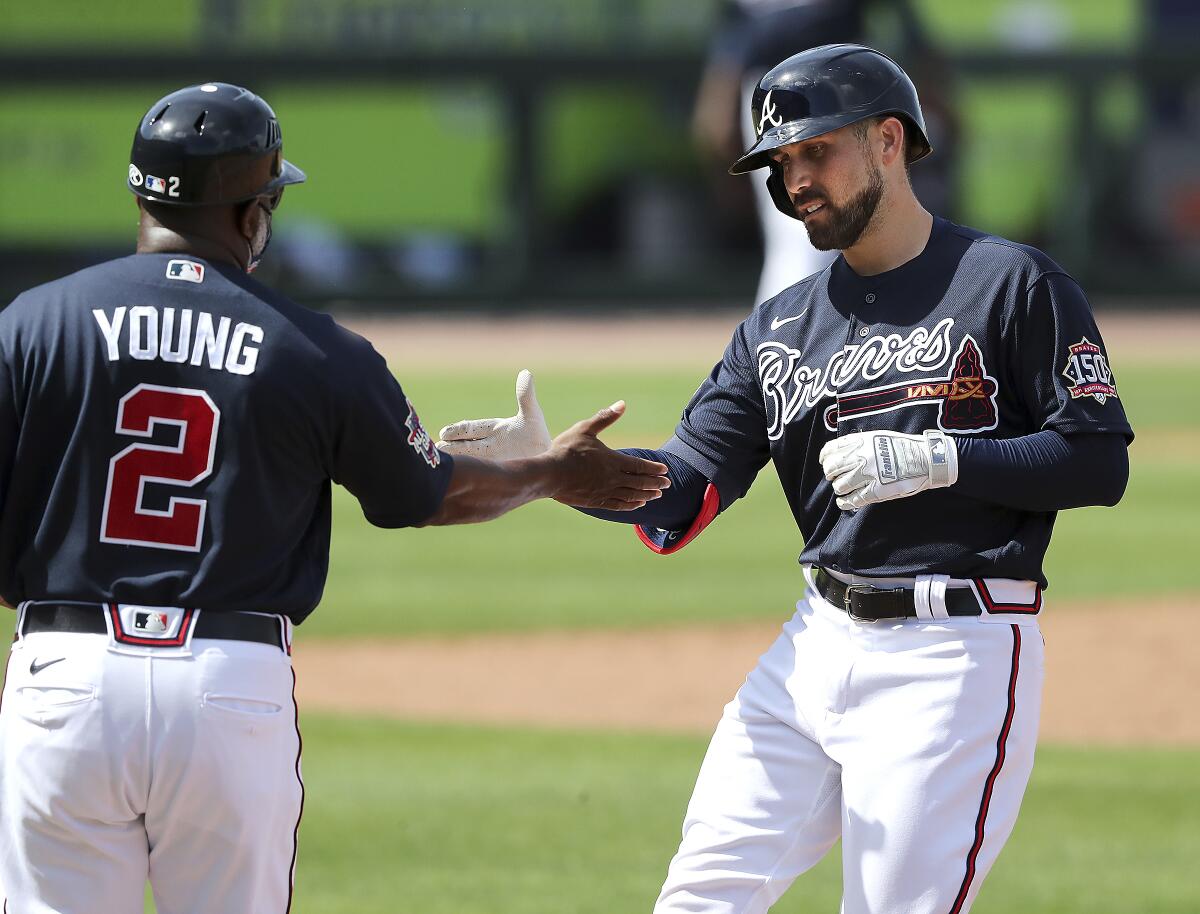 From left to right, Braves outfielders Adam Duvall, Cristian Pache