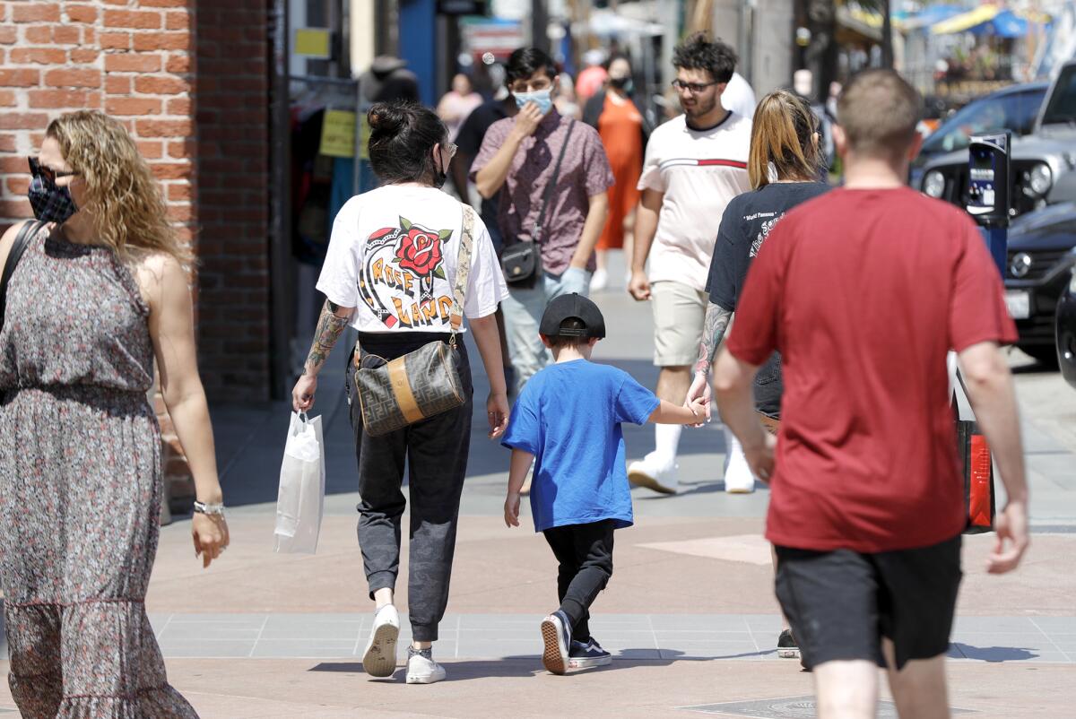 People walk on a sidewalk