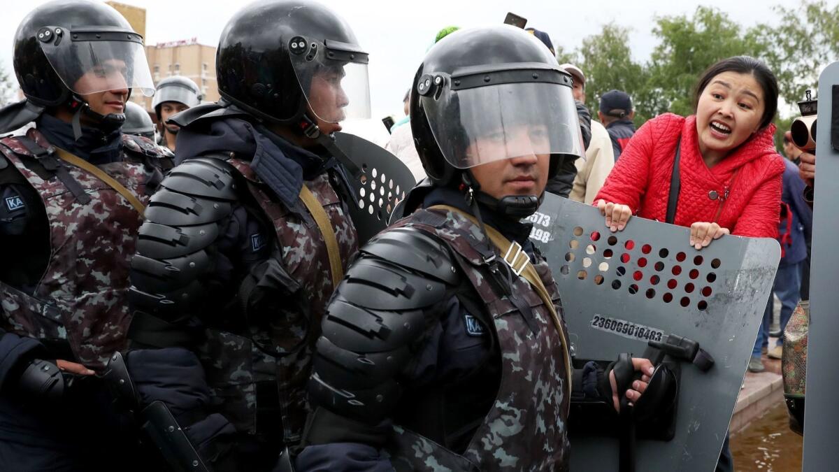 Opposition supporters clash with police during a protest calling for a free and fair vote during presidential elections in Nur-Sultan, Kazakhstan, on Sunday.