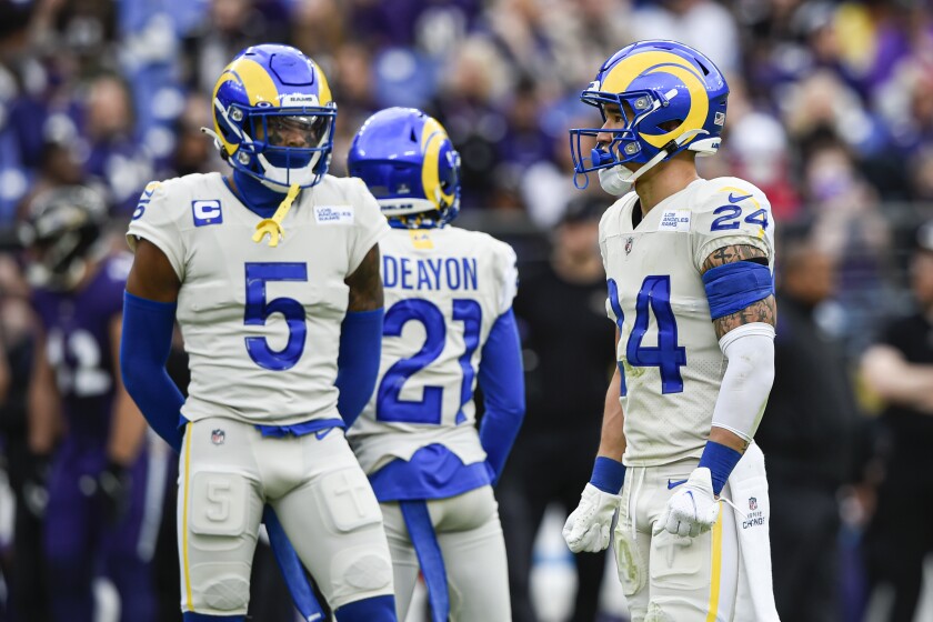 Los Angeles Rams cornerback Jalen Ramsey (5) looks in the direction of teammate free safety Taylor Rapp (24) during the first half of an NFL football game against the Baltimore Ravens, Sunday, Jan. 2, 2022, in Baltimore. Earlier in the first half, Ramsey threw a punch at Rapp after a play. (AP Photo/Gail Burton)