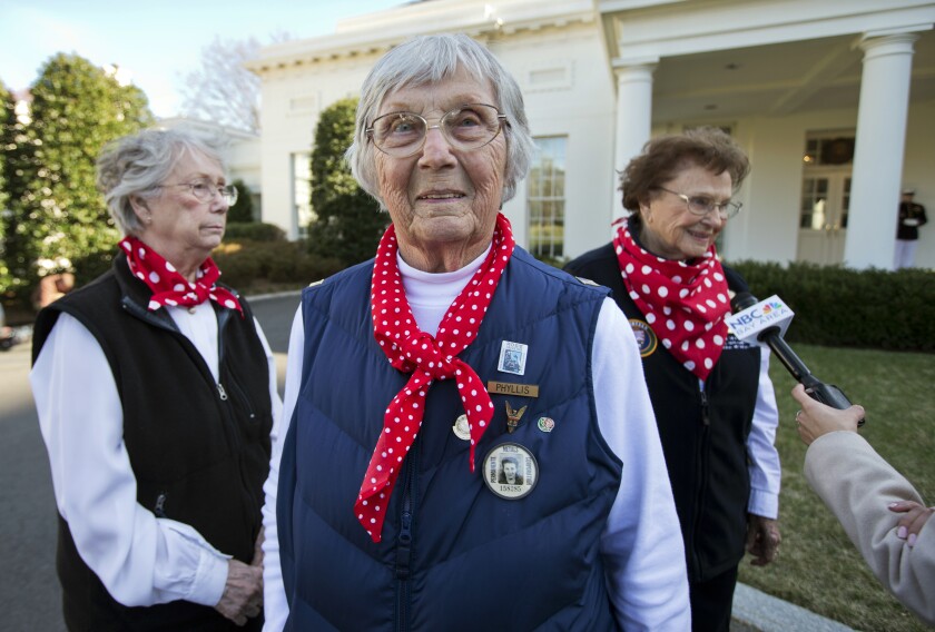 Phyllis Gould on the White House grounds with two other women in red and white polka-dot bandannas.