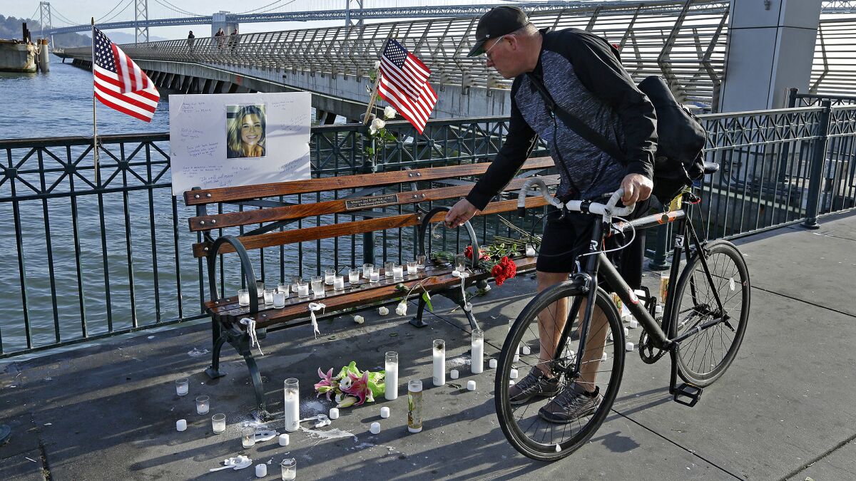 Craig Warner of Palo Alto, Calif., leaves a bell at a memorial site for Kathryn Steinle on Pier 14 in San Francisco on Friday.