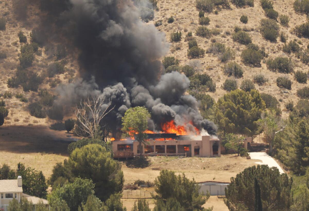 A house on fire on a hill