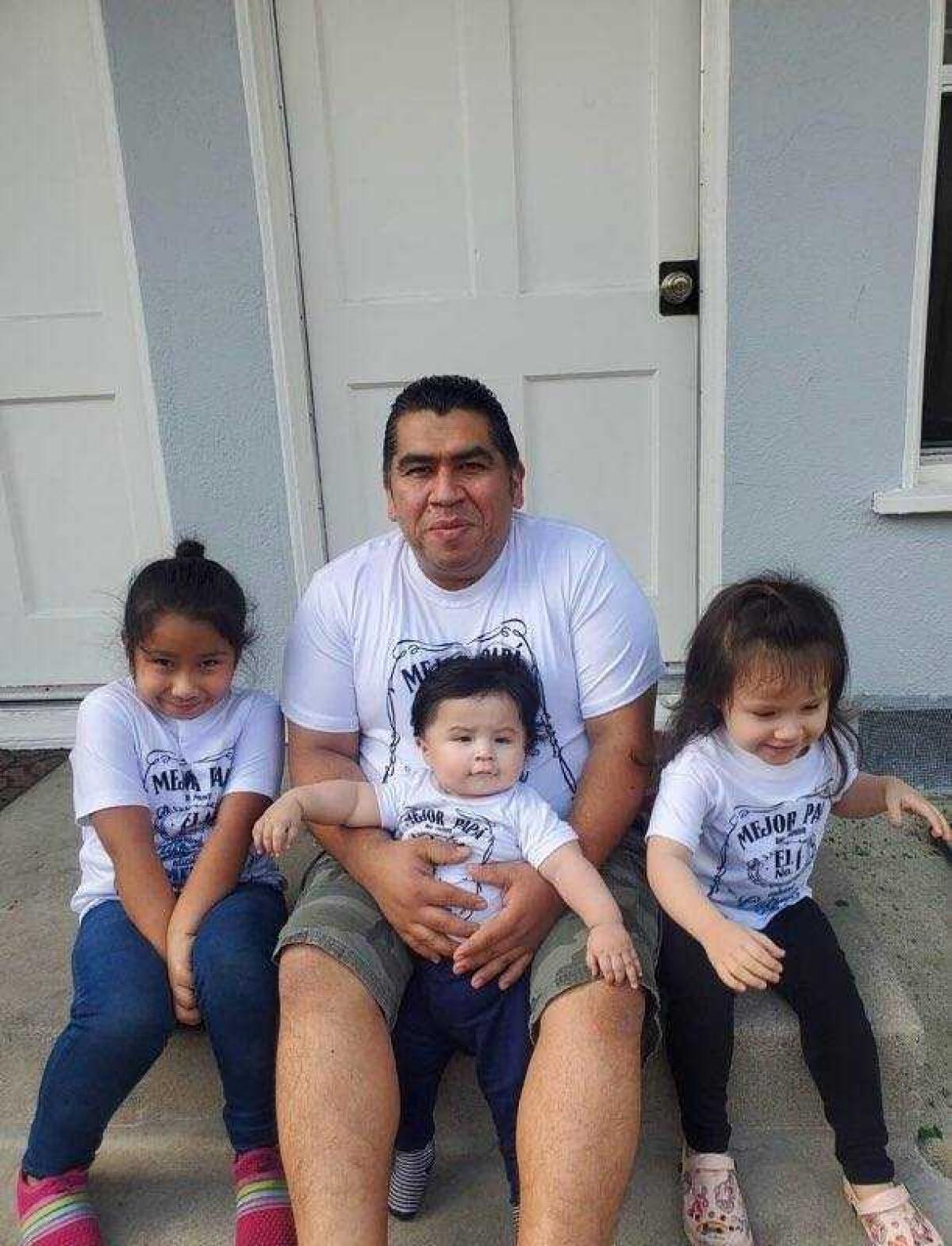 Luis Hernandez poses with his three children