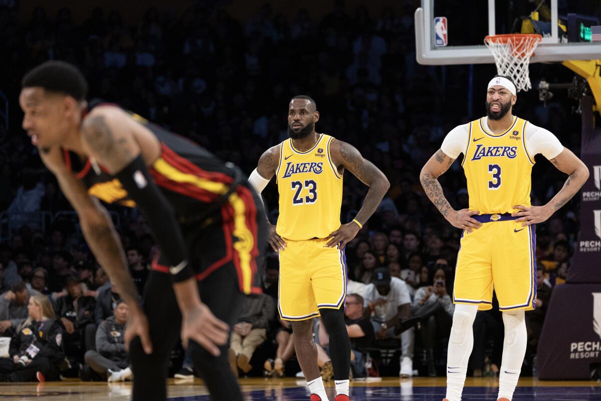 LeBron James and Anthony Davis stand backcourt during a foul shot.