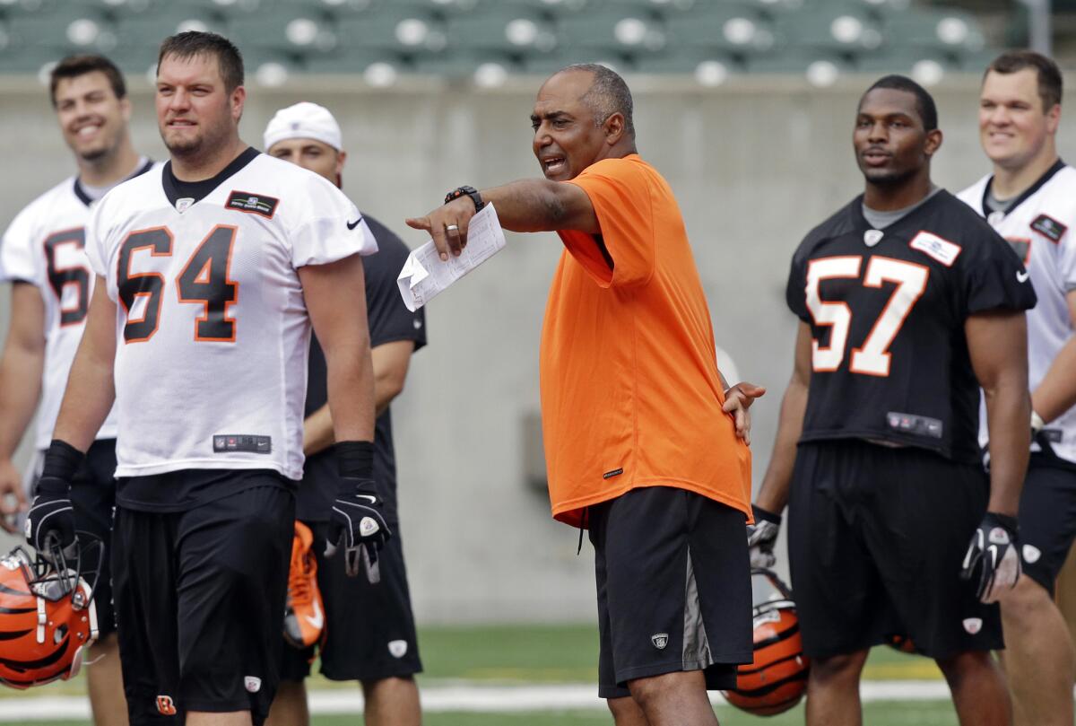 Cincinnati Bengals head Coach Marvin Lewis, center, directs practice during NFL football minicamp.