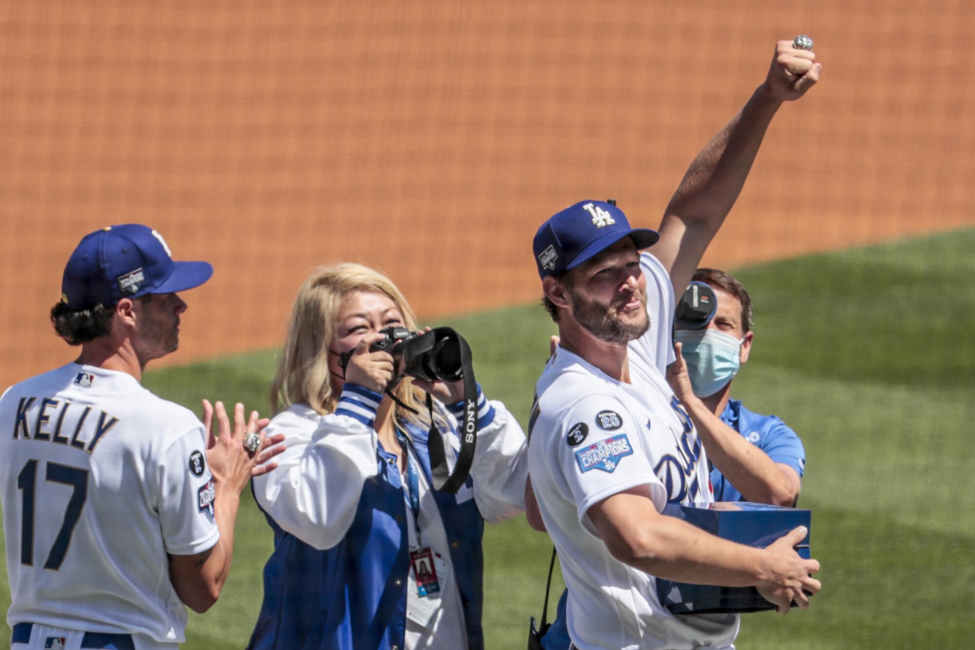 Clayton Kershaw shows off his World Series ring Friday during an on-field ceremony before the home opener at Dodger Stadium.