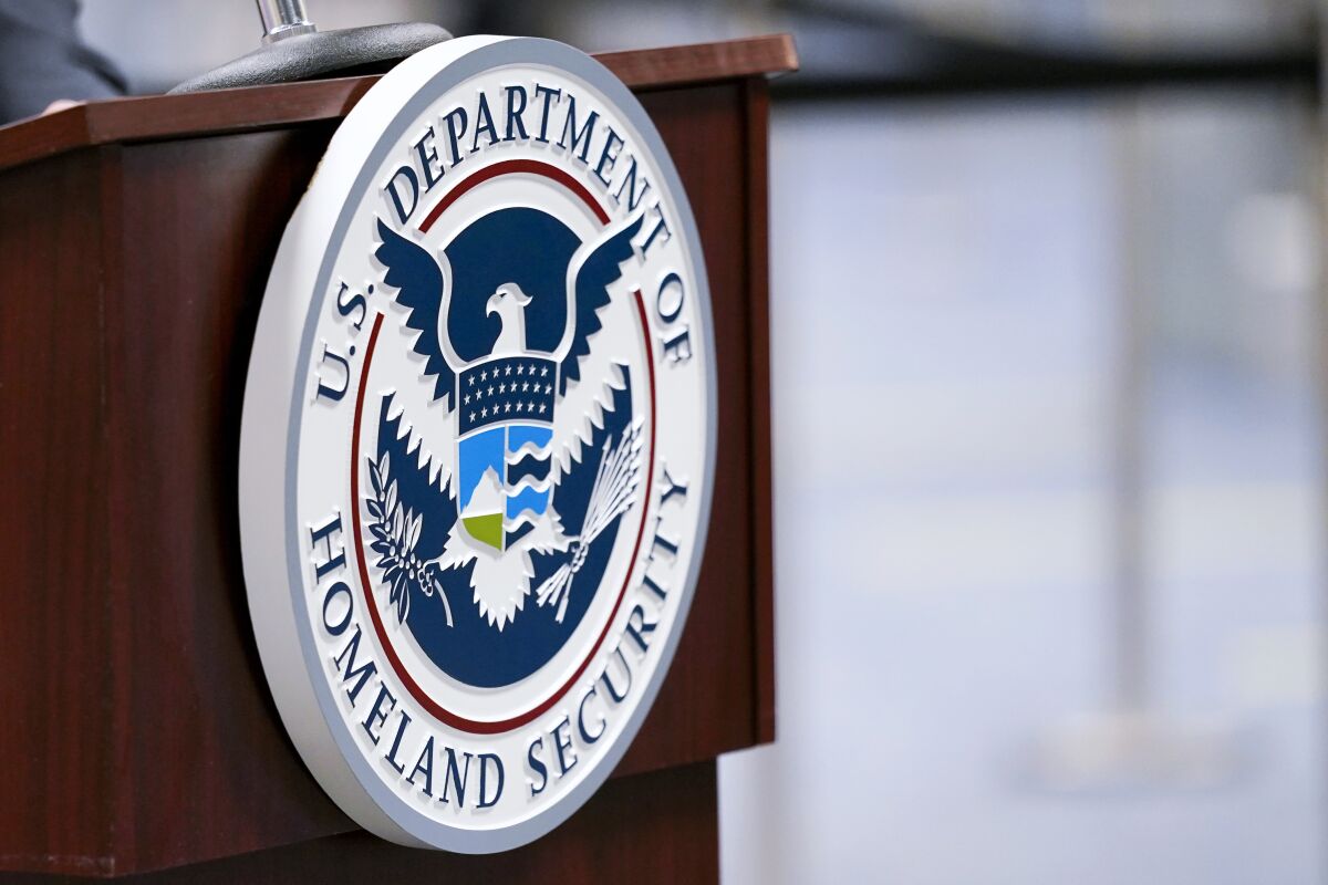 U.S. Department of Homeland Security plaque displayed on a podium.