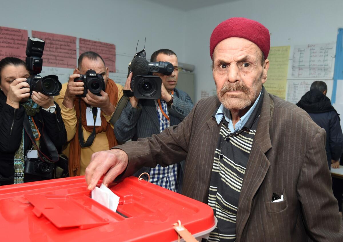 A man casts his vote at a polling station Sunday in Tunis, Tunisia.