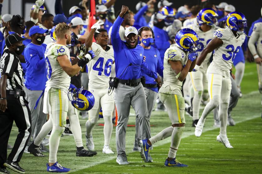 Los Angeles Rams safeties coach Ejiro Evero celebrates after an interception in the final minutes of an NFL Football game against the Tampa Bay Buccaneers, Monday, Nov. 23, 2020, in Tampa, Fla. (AP Photo/Kevin Sabitus)