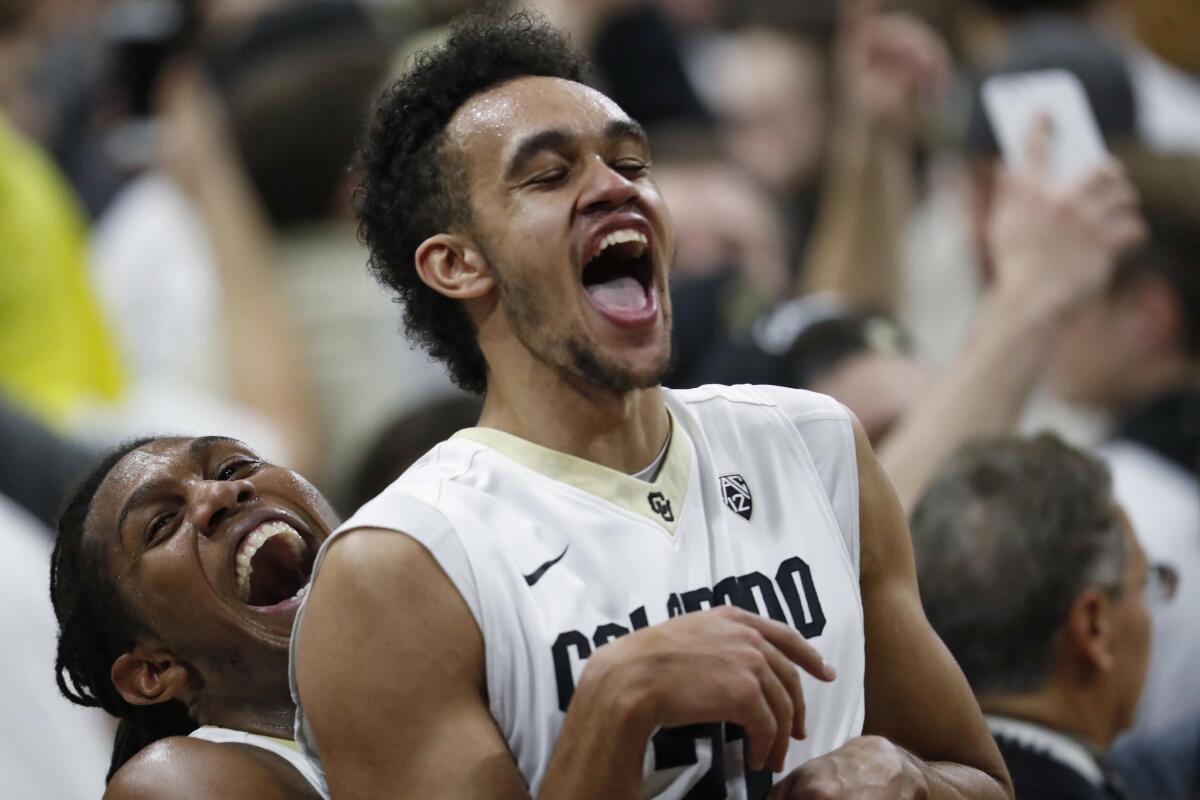 Colorado forward Xavier Johnson, left, hoists guard Derrick White at the end of the team's upset of No. 10 Oregon on Jan. 28.